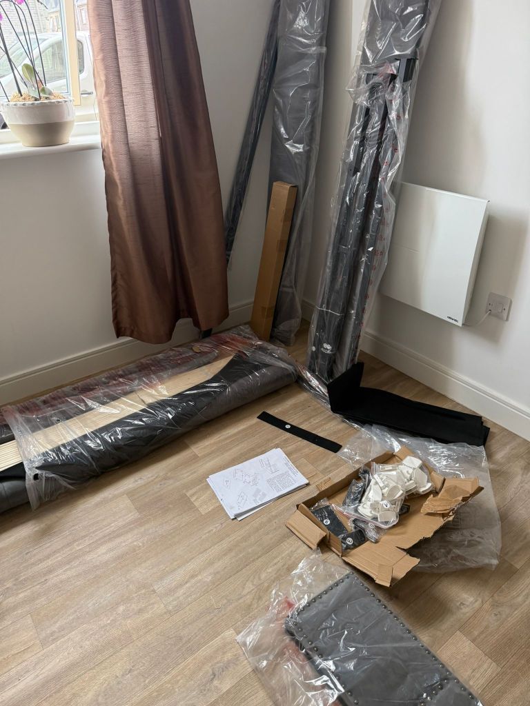 Flat-pack furniture parts laid out ready for assembly by a handyman