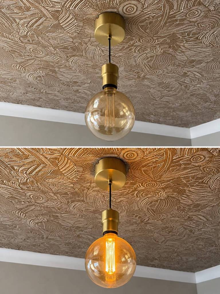 Handyman-installed pendant light fitting with Edison bulb against patterned wallpaper